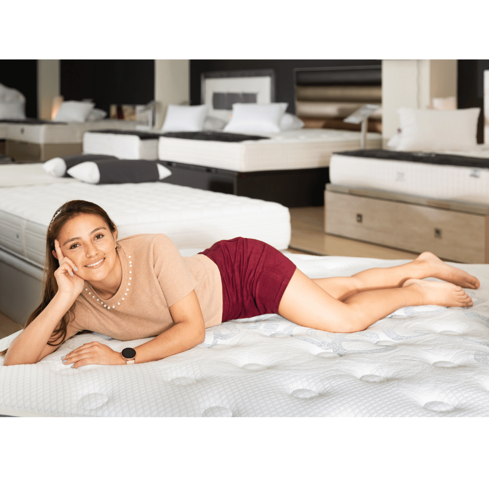 Woman testing mattress in store